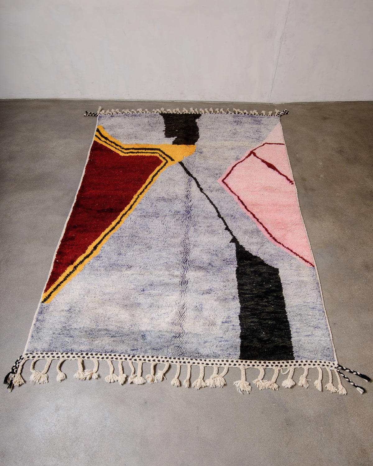 Berberlin Beni Ourain rug laying flat on concrete studio floor.